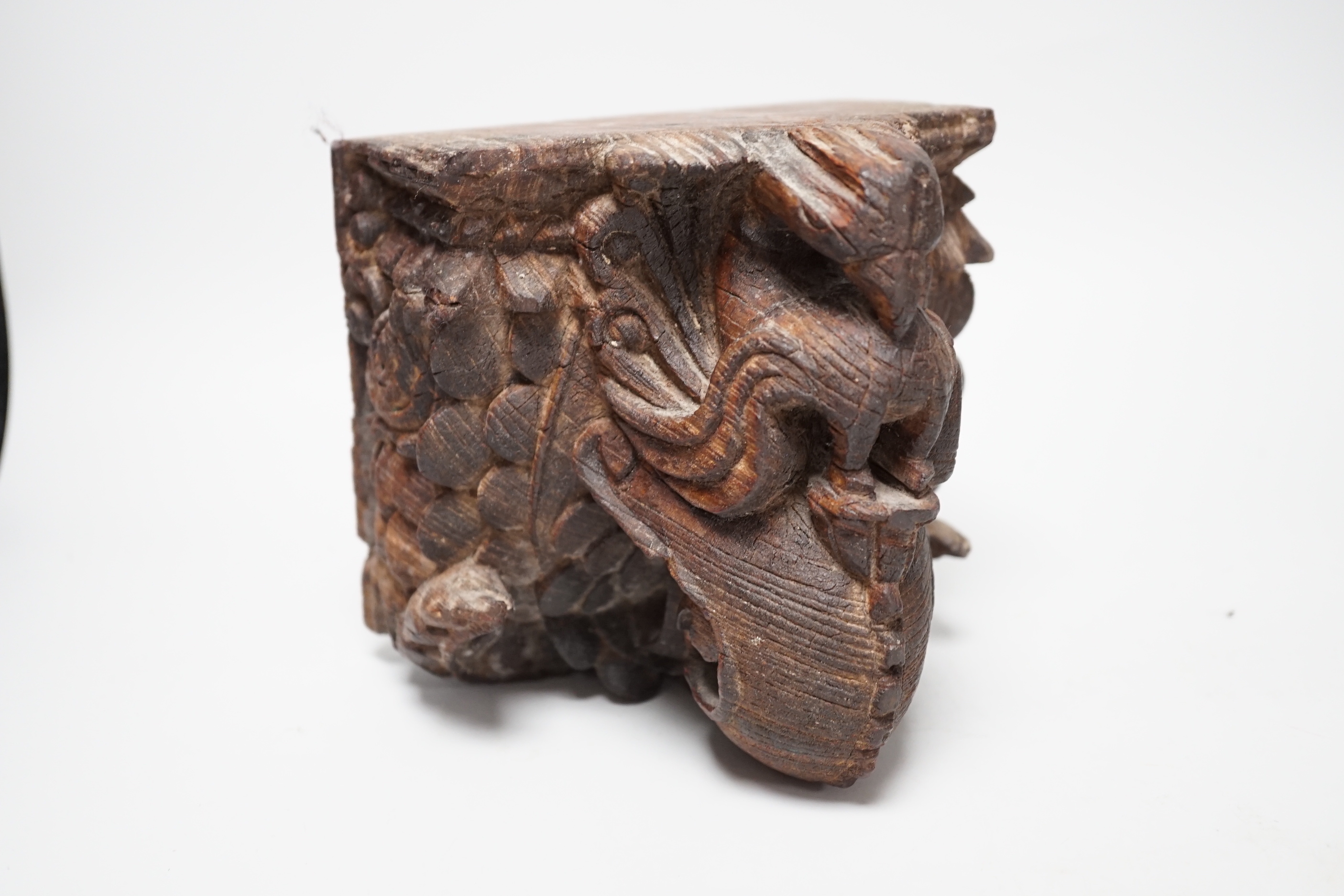 A carved South East Asian hardwood temple lion and an Indian wall bracket (2) tallest 23cm